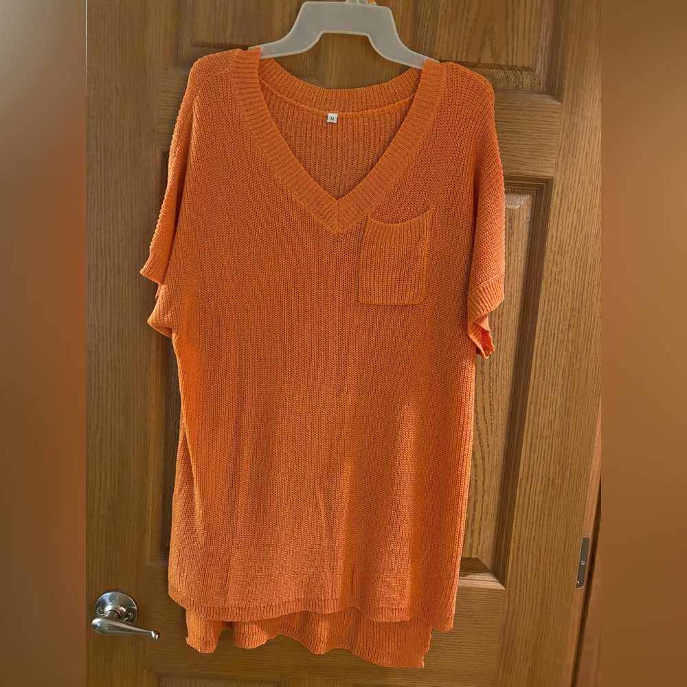 Short sleeved orange sweater top.